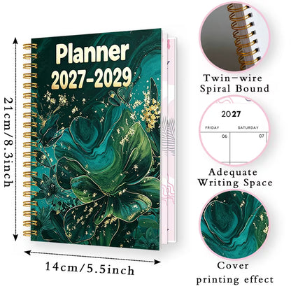Tuotekuva Planner 2027-2029 -kalenterista, jossa on tummanvihreä fluid art -tyylinen kukkakansi kultahippusilla ja kultainen kierresidonta.   