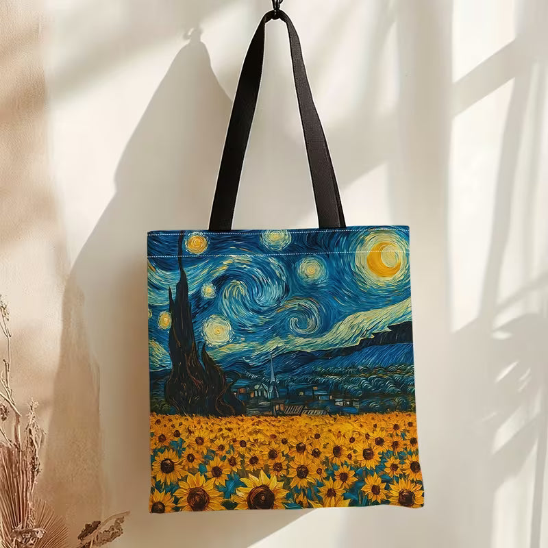 Sinikeltainen Van Gogh -kangaskassi, jossa yhdistyvät Tähtiyö-yötaivas ja auringonkukkapelto.